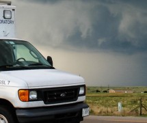 Stormy grey sky with National Severe Storms Laboratory truck in the foreground