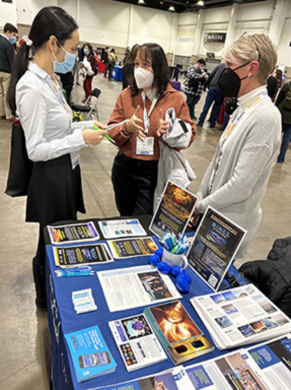 CPAESS Deputy Director Cindy Bruyere and Project Specialist Kate Rodd speak with a student interested in our educational opportunities such as internships, fellowships, and the NASA Heliophysics Summer School.