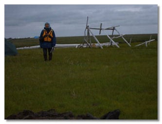 Man in front of fish camp