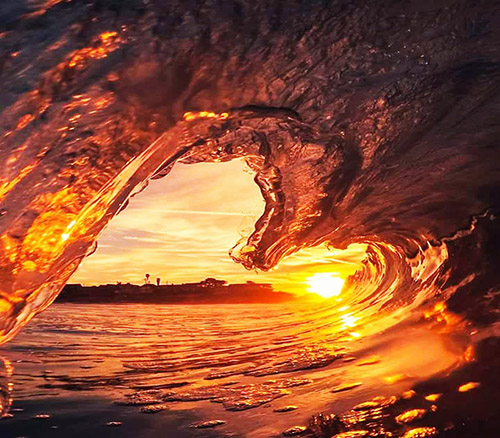 image of ocean wave at sunset