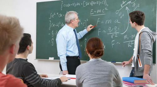 Teacher at chalk board