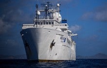 Large white ship on blue ocean water