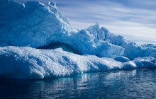 a group of icebergs floating on body of water