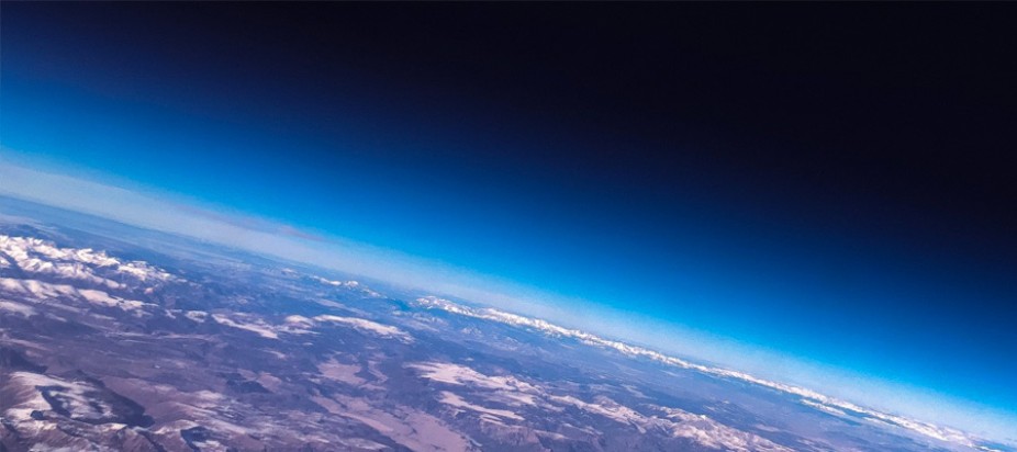 earth from space with blue horizon on black background