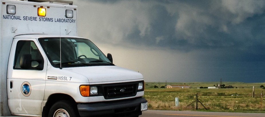 Stormy grey sky with National Severe Storms Laboratory truck in the foreground