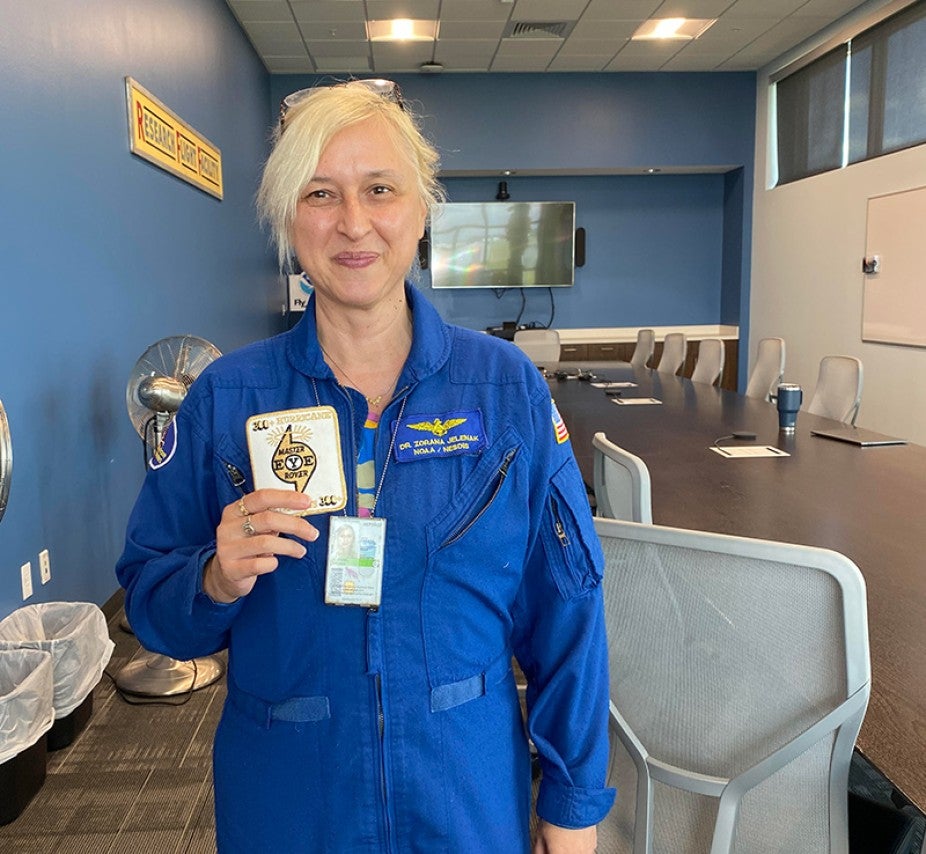 woman with blond hair in blue jumpsuit