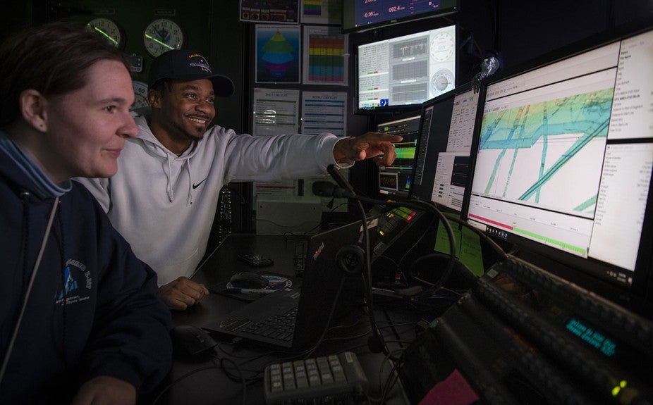 two students looking at monitors