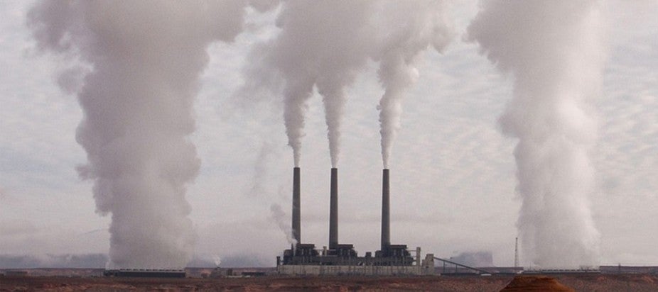 three smokestacks with billowing gases