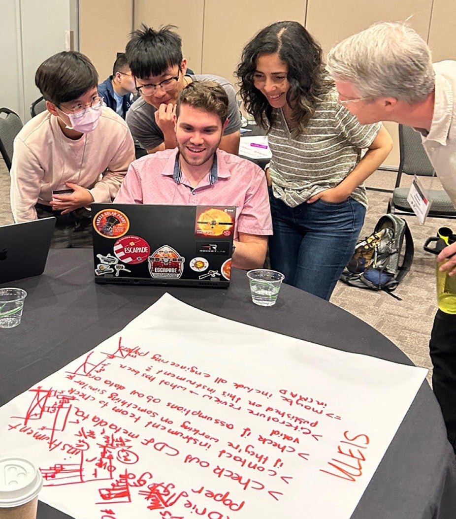 Students working together around a computer