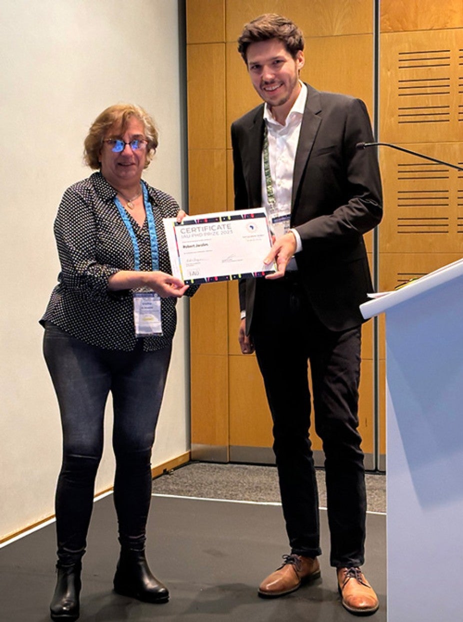 Robert receiving the 2023 International Astronomical Union’s Ph.D.