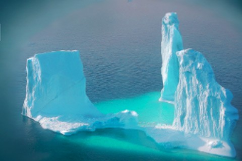 blue icebergs on dark blue ocean in daylight