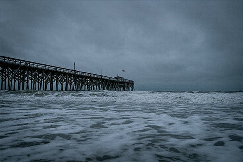 brown wooden dock in storm