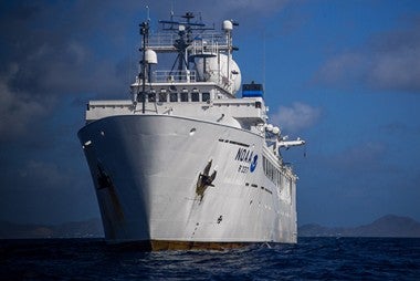 Large white ship on blue ocean water