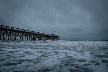 brown wooden dock in storm
